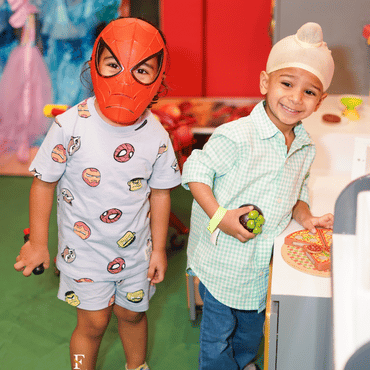 Children enjoying superhero-themed pretend play at Wooray Delhi.