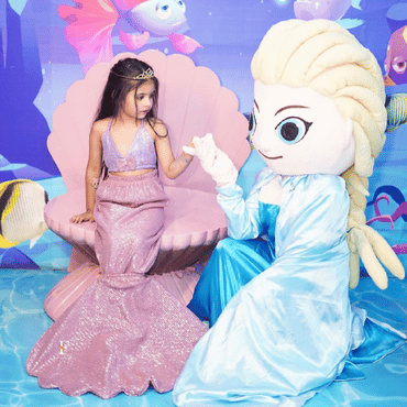 Two children dressed as mermaids enjoying an underwater-themed experience at Wooray Hyderabad.