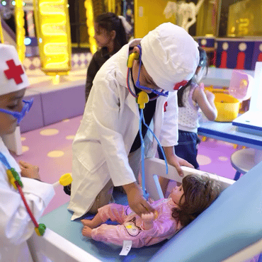 Children enjoying a pretend doctor activity at Wooray Hyderabad indoor play area.