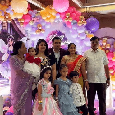 Family celebrating a birthday together at Wooray Hyderabad with colourful balloon decorations.