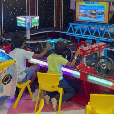 Children playing an interactive racing game at the arcade area of Wooray Hyderabad.
