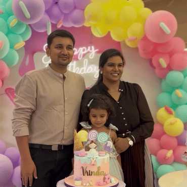 Family celebrating a child's birthday with a colourful decorated cake at Wooray Hyderabad.