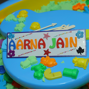 Child enjoying a creative activity with colourful shapes at Wooray Patna indoor play area.