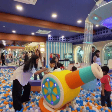Children enjoying an interactive cannon game in the ball pit at Wooray Dehradun.